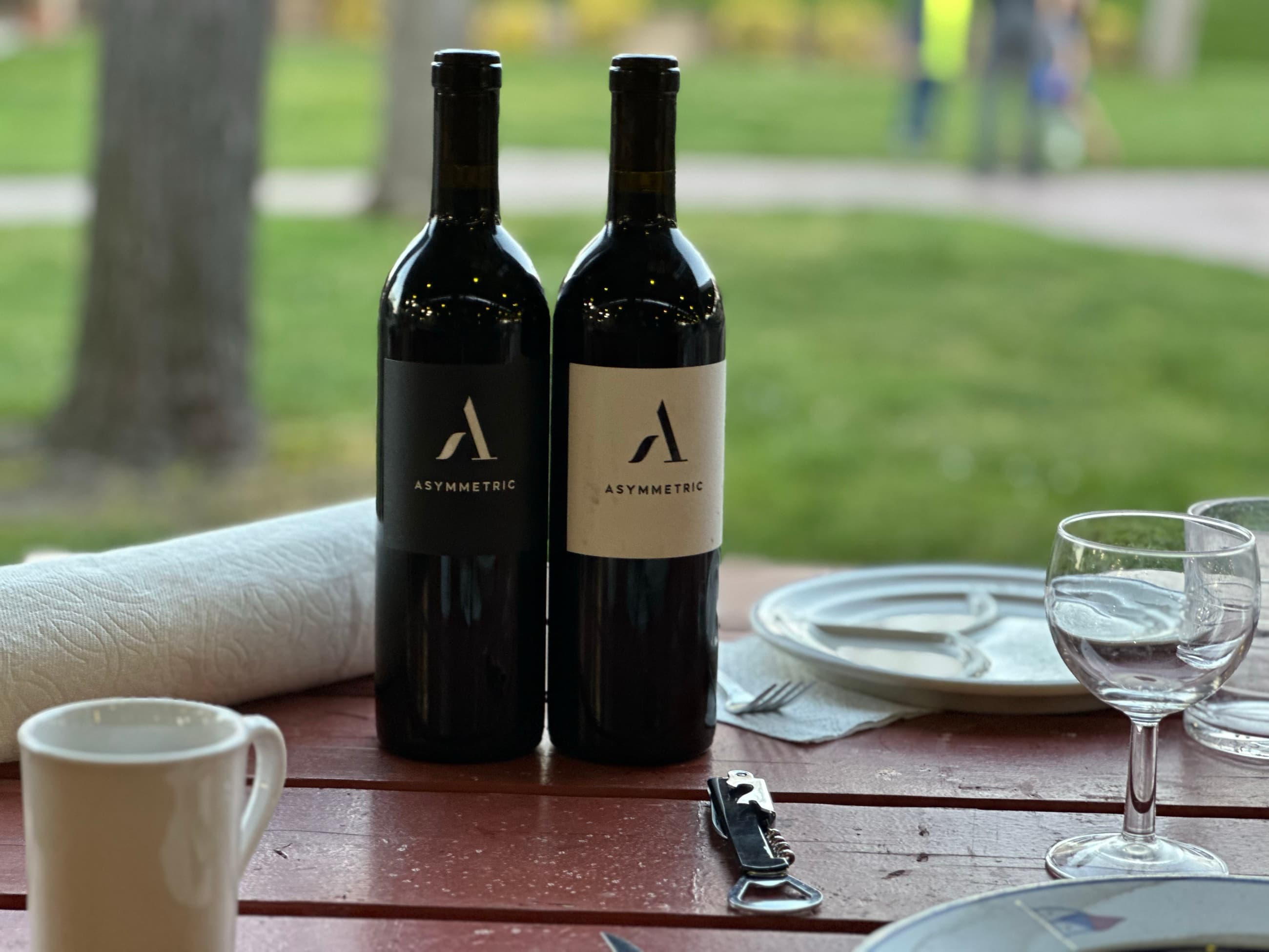 Two bottles of Asymmetric wine set for a private tasting